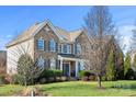 Two-story house with brick and siding, nicely landscaped at 5225 Firebrick Sw Ln, Concord, NC 28025