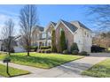 Large brick home with a side driveway and mature trees at 5225 Firebrick Sw Ln, Concord, NC 28025