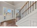Bright foyer with wood floors, white wainscoting, and an ornate staircase at 128 Balboa St # 25, Matthews, NC 28104