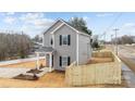 View of the side of a two-story gray home with a fenced yard at 402 N Battleground Ave, Kings Mountain, NC 28086