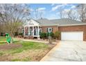 Brick ranch house with attached garage and large yard at 8007 Stevens Mill Rd, Matthews, NC 28104