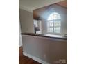 View of the kitchen through a pass-through window from the dining area at 8231 Southgate Commons Dr, Charlotte, NC 28277