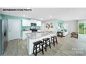 Modern kitchen with white cabinets, granite countertops, and island at 1063 Horizon Ln, Chester, SC 29745