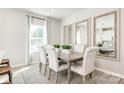 Bright dining room with a rustic table and six chairs at 1805 Woodlands Pointe Dr, Charlotte, NC 28216