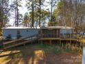 Mobile home with large deck and ramp access, surrounded by trees at 5040 Spicewood Dr, York, SC 29745
