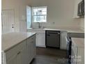 Modern kitchen with white quartz countertops, stainless steel appliances, and ample cabinet space at 1713 N Clay St, Salisbury, NC 28144