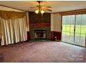 Living room with stone fireplace and sliding glass doors at 221 Avon Park Ln, Taylorsville, NC 28681