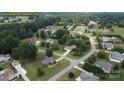 An aerial view of houses in a neighborhood with green lawns and trees at 257 Donsdale Dr, Statesville, NC 28625