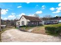 One-story house with a screened porch, driveway, and landscaping at 45 Sunderland Rd, Concord, NC 28027