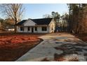 Modern farmhouse with a paved driveway and landscaped yard at 615 E Ridge Rd, Salisbury, NC 28144