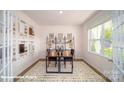 Bright home office with two desks, large window, French doors, and patterned rug at 110 Windstone Common Ln, Mooresville, NC 28117