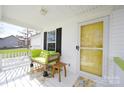 Inviting front porch with a comfy couch and a yellow front door at 1274 Bicycle Ct, York, SC 29745