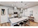 Modern kitchen with gray cabinets, white countertops, and island with bar seating at 2735 Texana Ct, Charlotte, NC 28269