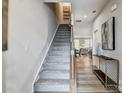 Carpeted staircase with wooden railing leading to the second floor at 2735 Texana Ct, Charlotte, NC 28269