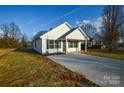 Newly built home with gray shutters and a front yard at 412 Lytton St, Troutman, NC 28166