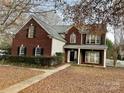 Two-story house with brick and siding exterior, a walkway, and landscaping at 2001 Sentinel Dr, Indian Trail, NC 28079