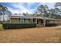 Brick ranch house with green shutters, solar panels, and a landscaped yard at 753 Schuyler Dr, Rock Hill, SC 29730