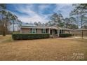 Brick ranch house with green shutters, solar panels, and a landscaped yard at 753 Schuyler Dr, Rock Hill, SC 29730