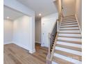 Modern light wood staircase with black metal balusters leading to the second floor at 1526 Levy Way, Charlotte, NC 28205