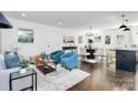 Open concept dining area with modern chandelier and hardwood floors at 2038 Sandhurst Dr, Charlotte, NC 28205