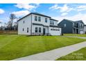 Two-story house with white siding, gray roof, and stone accents at 3050 Swallowtail Ln, Kannapolis, NC 28083