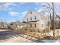 Two-story house with white and beige siding, wooden fence, and a landscaped yard at 626 Smith St, Kannapolis, NC 28083