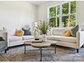 Bright living room with comfortable sofas, a coffee table, and a large window at 7022 Impulse Ct, Charlotte, NC 28205