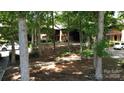 Aerial view showing condo building nestled in a wooded setting at 849 Nottingham Dr # 62, Gastonia, NC 28054