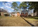 Brick ranch home with a large yard and mature trees at 1551 Rolling Meadow Ln, Gastonia, NC 28054