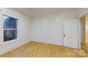 Well-lit bedroom featuring hardwood floors and an open door at 212 E 11Th St, Salisbury, NC 28144