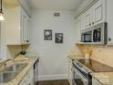 Modern kitchen with granite counters, stainless steel appliances, and white cabinets at 224 N Poplar St # 19, Charlotte, NC 28202
