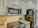 Stainless steel appliances and granite countertops in this updated kitchen at 224 N Poplar St # 19, Charlotte, NC 28202