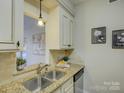 Modern kitchen with granite countertops and stainless steel appliances at 224 N Poplar St # 19, Charlotte, NC 28202