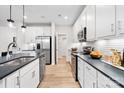 Modern kitchen with white cabinets, stainless steel appliances, and dark countertops at 8016 Franklin Trail St, Mint Hill, NC 28227