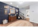 Stylish basement features a built-in media console, wood accent wall, and a cozy sitting area at 9552 Man O War Rd, Indian Land, SC 29707