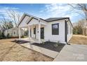 Stylish white house with black accents, a covered porch and landscaped yard at 1016 S Confederate Ave, Rock Hill, SC 29730