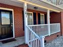 Black front door with sidelights and white porch railing at 1361 Fairhope Rd, York, SC 29745