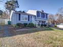 Gray sided two-story house with landscaping and a walkway at 7800 Highbanks Ct, Charlotte, NC 28212
