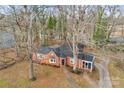 Ranch house surrounded by tall trees, driveway, and yard at 860 W Marion St, Shelby, NC 28150