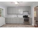 Renovated kitchen with gray cabinets and quartz countertops at 4658 Murrayhill Rd, Charlotte, NC 28209