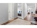 Bright hallway with wood floors and views of bedroom and living area at 7112 Wayfarer Dr # 0081, Charlotte, NC 28269