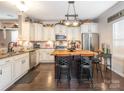 Kitchen with island, granite countertops, and wooden cabinets at 7004 Mclothian Ln, Huntersville, NC 28078