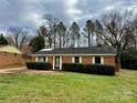 Brick ranch house with a well-maintained lawn at 8717 Windsong Dr, Charlotte, NC 28273