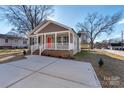 Newly built house with a red door and spacious driveway at 1215 Pless Nw St, Concord, NC 28027