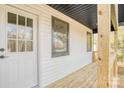 White front door and wood porch with a view of the yard at 623 Edna Graves Way, Cherryville, NC 28021