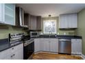 Modern kitchen with stainless steel appliances and dark countertops at 6726 Wannamaker Ln, Charlotte, NC 28226