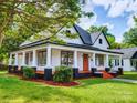 Updated home with a large front porch, landscaping and walkway at 215 N King St, Gastonia, NC 28052