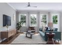 Spacious living room with teal sofa and large windows at 5684 Clear Creek Ln, Charlotte, NC 28215