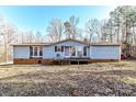 Ranch style home with deck and wooded backdrop at 8327 Walkup Rd, Waxhaw, NC 28173