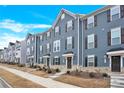 Row of townhouses with gray siding and brown shutters at 2407 Autumn Olive Ln, Stallings, NC 28104